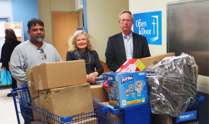 Prodigy Graphics Bindery Manager Rafeek Sultan, The Open Door Executive Director Lynne Culham and Prodigy Graphics CEO Gordon McCauley